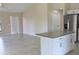 Open kitchen with granite island and view into living area at 150 Sterling St, Port Charlotte, FL 33954