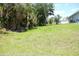 Large lush backyard with mature trees and green grass; perfect for recreation at 310 Day Break Cir, Port Charlotte, FL 33954