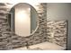 Bathroom vanity with a round mirror and stylish tile backsplash at 310 Day Break Cir, Port Charlotte, FL 33954