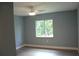 Bedroom with a window view of the outdoors and ceiling fan at 310 Day Break Cir, Port Charlotte, FL 33954