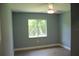 Bedroom featuring a ceiling fan, light grey paint, and a window providing plenty of natural light at 310 Day Break Cir, Port Charlotte, FL 33954