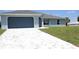 Charming single-Gathering home with a grey finish, concrete tile driveway, and manicured lawn at 310 Day Break Cir, Port Charlotte, FL 33954