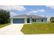 Beautiful single-story home featuring a gray finish, concrete tile driveway, and well-kept lawn at 310 Day Break Cir, Port Charlotte, FL 33954