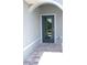Welcoming front entrance with a tiled walkway and a stylish front door at 310 Day Break Cir, Port Charlotte, FL 33954