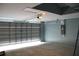 Spacious garage with an automatic door, light blue walls, and an accessible attic hatch at 310 Day Break Cir, Port Charlotte, FL 33954