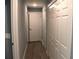 Hallway view features sleek grey wood-look flooring, modern lighting and closets at 310 Day Break Cir, Port Charlotte, FL 33954
