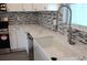 Close up on kitchen sink, marble countertops, backsplash and stainless steel appliances at 310 Day Break Cir, Port Charlotte, FL 33954