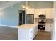 Bright kitchen featuring white cabinets, stainless steel appliances, and a marble-top island at 310 Day Break Cir, Port Charlotte, FL 33954