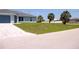 Newly installed lawn outside of this one story home that is surrounded by beautiful mature trees at 310 Day Break Cir, Port Charlotte, FL 33954