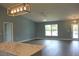 Spacious living room featuring modern light fixtures and an expansive floor plan at 310 Day Break Cir, Port Charlotte, FL 33954