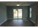 Bright, open living room with sliding glass doors and wood-look flooring at 310 Day Break Cir, Port Charlotte, FL 33954