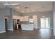 Open living area with a vaulted ceiling, stylish light fixtures, and a kitchen area at 310 Day Break Cir, Port Charlotte, FL 33954