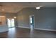 Spacious living area featuring gray flooring, a ceiling fan, and ample natural light at 310 Day Break Cir, Port Charlotte, FL 33954