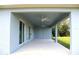 Covered patio featuring dual ceiling fans and views of the backyard at 310 Day Break Cir, Port Charlotte, FL 33954