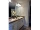 Double vanity bathroom with modern fixtures and a large mirror at 1139 Euclid Rd, Venice, FL 34293