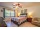 Bedroom with striped bedding and ceiling fan at 4450 47Th W Ave # 202, Bradenton, FL 34210