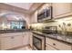 Modern kitchen with stainless steel appliances and granite countertops at 4450 47Th W Ave # 202, Bradenton, FL 34210