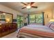 Main bedroom with striped bedding and access to a balcony at 4450 47Th W Ave # 202, Bradenton, FL 34210
