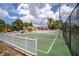 Outdoor basketball court surrounded by a white fence with lush tropical landscaping nearby at 4450 47Th W Ave # 202, Bradenton, FL 34210