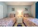 Guest bedroom with twin beds and shared bathroom at 4450 47Th W Ave # 202, Bradenton, FL 34210