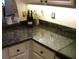 Kitchen features dark granite countertops and white cabinets at 4450 47Th W Ave # 202, Bradenton, FL 34210