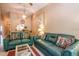 Living room with teal couches and a view into the kitchen at 4450 47Th W Ave # 202, Bradenton, FL 34210