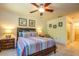 Main bedroom with striped bedding and en-suite bathroom at 4450 47Th W Ave # 202, Bradenton, FL 34210