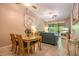 Open living and dining area with tiled floors and access to a balcony at 4450 47Th W Ave # 202, Bradenton, FL 34210