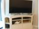 Living room with corner entertainment center and large TV at 4450 47Th W Ave # 202, Bradenton, FL 34210