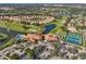 Stunning aerial view of a community with golf course, tennis courts, lakes, clubhouse and parking at 4989 Clubview E Ct, Bradenton, FL 34203