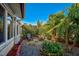 Cozy backyard with a stone firepit and two brown chairs surrounded by tropical foliage at 4989 Clubview E Ct, Bradenton, FL 34203