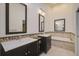 Well-lit bathroom featuring double vanities and a luxurious soaking tub with decorative tile accents at 4989 Clubview E Ct, Bradenton, FL 34203