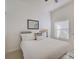 Inviting bedroom with white bedding, decorative pillows, and a window for natural light at 4989 Clubview E Ct, Bradenton, FL 34203
