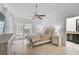 Bright bedroom with a ceiling fan, tile floors, and French doors to the outside at 4989 Clubview E Ct, Bradenton, FL 34203