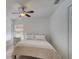 Comfortable bedroom with a ceiling fan, neutral decor, and a window for natural light at 4989 Clubview E Ct, Bradenton, FL 34203