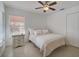 Cozy bedroom with neutral tones, ceiling fan, and tile flooring at 4989 Clubview E Ct, Bradenton, FL 34203