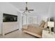 Comfortable bedroom with a ceiling fan, tile floors, dresser, and French doors to the outside at 4989 Clubview E Ct, Bradenton, FL 34203