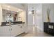 Elegant entryway features a wet bar, light tile floors, and a view into the dining room at 4989 Clubview E Ct, Bradenton, FL 34203