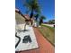 Home exterior featuring brick walkway with bright stone landscaping and beautiful palm trees at 4989 Clubview E Ct, Bradenton, FL 34203