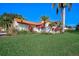 This well-maintained home features mature landscaping, a red tile roof, and a neatly manicured lawn at 4989 Clubview E Ct, Bradenton, FL 34203