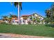 Attractive single-story home with vibrant landscaping, a red tile roof, and a neatly manicured green lawn at 4989 Clubview E Ct, Bradenton, FL 34203