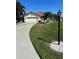 Well-manicured lawn and landscaped front yard with stone accents lead to this lovely home at 4989 Clubview E Ct, Bradenton, FL 34203