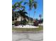 Attractive landscaping with palms and stone features adds curb appeal to this property at 4989 Clubview E Ct, Bradenton, FL 34203