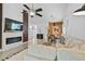 Inviting living room with fireplace, flatscreen television and modern ceiling fan fixture at 4989 Clubview E Ct, Bradenton, FL 34203