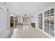 Bright living room with white walls, tile flooring, and access to the outdoors through sliding glass doors at 4989 Clubview E Ct, Bradenton, FL 34203