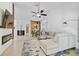 Bright and airy living room featuring a modern ceiling fan and comfortable sectional seating at 4989 Clubview E Ct, Bradenton, FL 34203