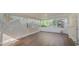 Wide screened porch offering lots of space, with wood-look flooring and garden views at 4989 Clubview E Ct, Bradenton, FL 34203
