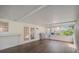 Spacious screened porch featuring wood-look flooring, grill and views of lush landscaping at 4989 Clubview E Ct, Bradenton, FL 34203