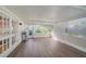 Large screened porch with wood-look flooring, grill, and outdoor access, perfect for entertaining guests at 4989 Clubview E Ct, Bradenton, FL 34203
