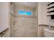 Modern glass enclosed shower featuring tiled walls, a window, and a built-in seat at 4989 Clubview E Ct, Bradenton, FL 34203